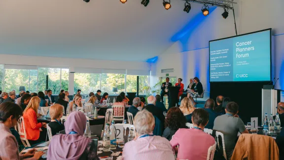 People sitting at round tables during the Cancer Planners Forum 2025